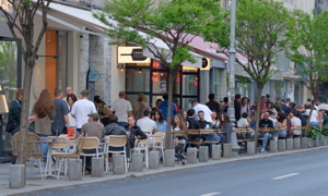 Cityscape with people relaxing on terraces